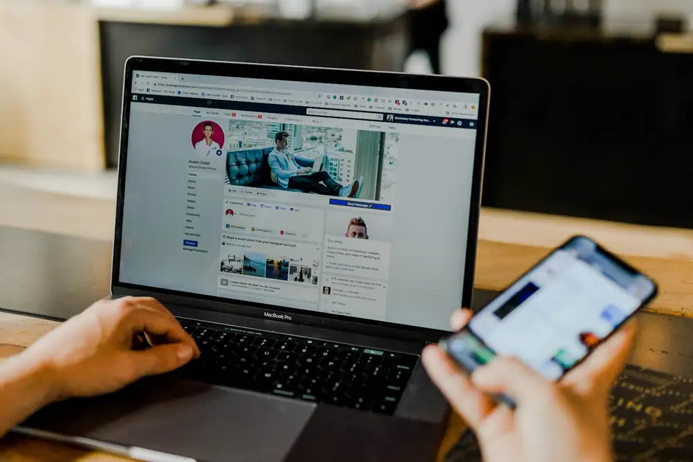 Facebook open on a laptop and a smartphone
